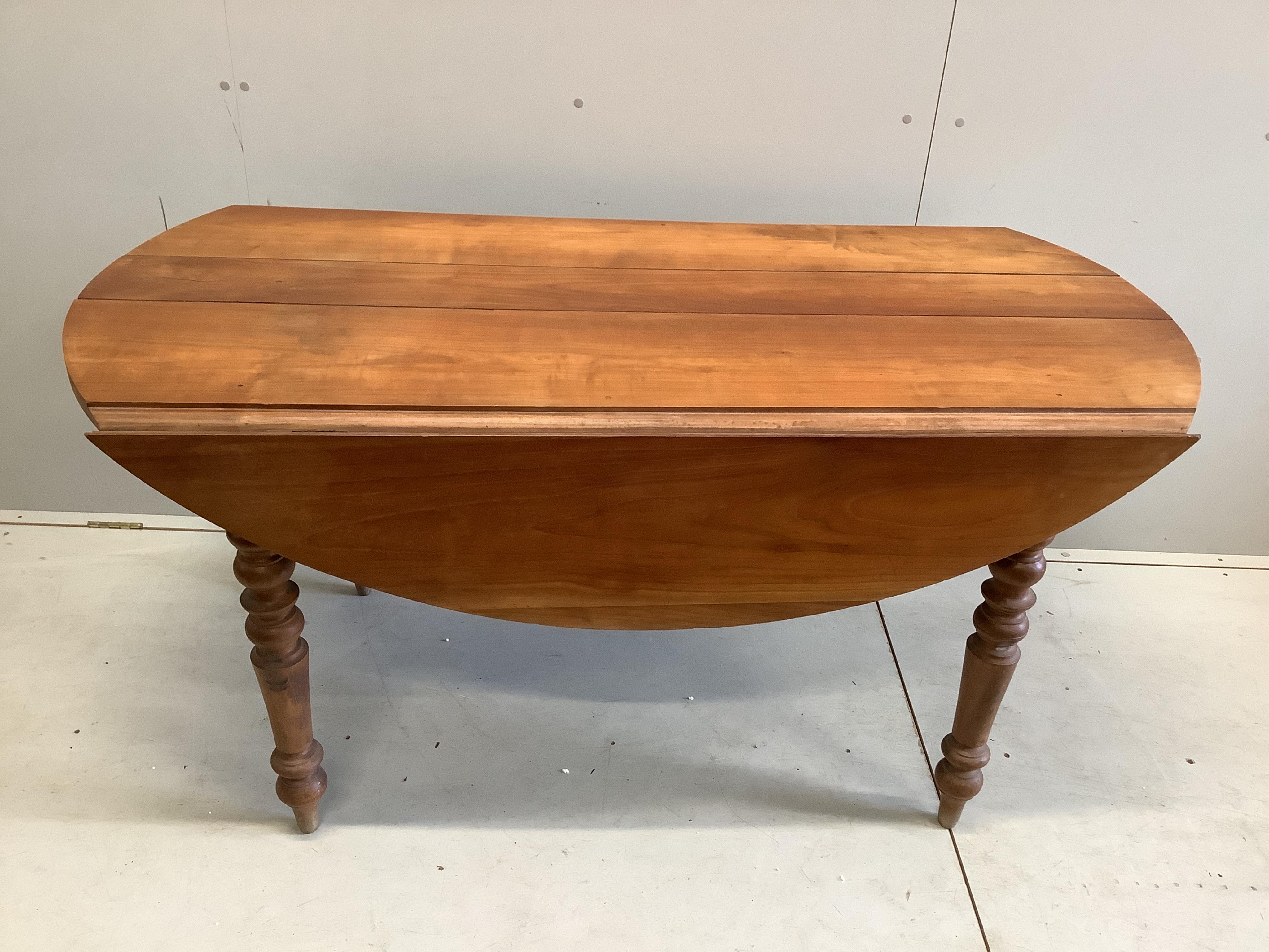 A 19th century French drop leaf cherry kitchen table, width 150cm, depth 75cm, height 74cm. Condition - poor